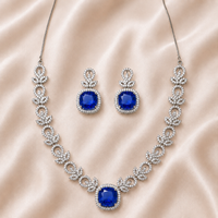 Jewelry set with necklace and earrings featuring blue gemstones
